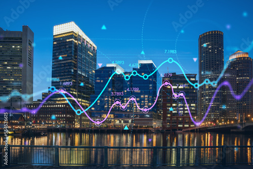 City view panorama of Boston Harbor and Seaport Blvd at night time, Massachusetts. Financial downtown. Glowing FOREX graph hologram. The concept of international trading and fundamental analysis