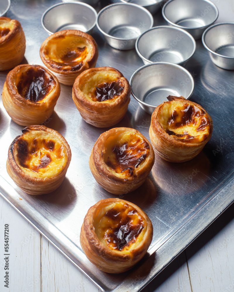 Delicious egg tart on tray, Portugese custard egg tart or Pastel de nata, Hong Kong tart egg straight out from oven. Delicious egg tart on tray, Portugese custard egg tart or Pastel de nata, Hong Kong tart egg straight out from oven.