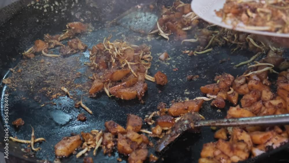 char kuey kak Fried Rice Cake food is put into paper plate. Delicious Malaysia street food char kuey kak Fried Rice Cake food is put into paper plate. Delicious Malaysia street food