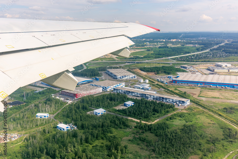 View from the airplane window during taking off on a clear summer morning. Yekaterinburg, Russia View from the airplane window during taking off on a clear summer morning. Yekaterinburg, Russia