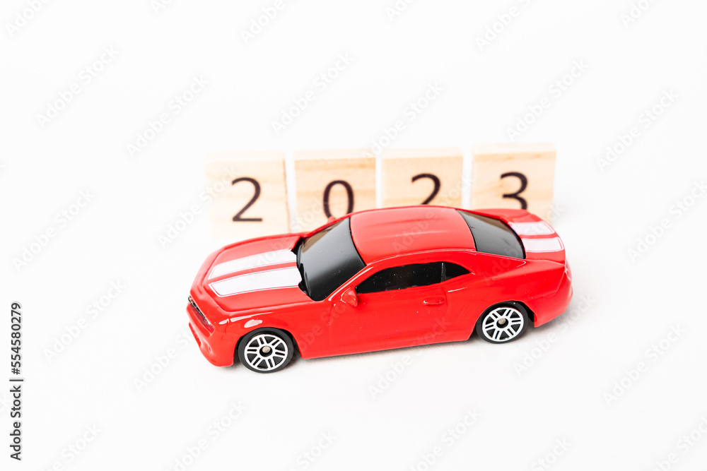 2023 Wooden numbers are isolated on white background. Festive red car copy space 2023 Wooden numbers are isolated on white background. Festive red car copy space