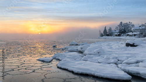 Frosty morning and freezing sea at sunrise