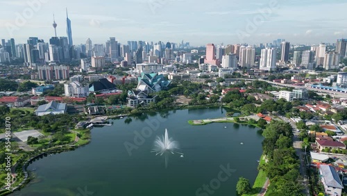 Aerial view green lush scenery of fountain at Taman Tasik Titiwangsa with background of KL building photo