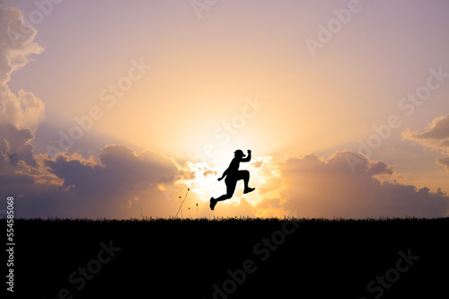 silhouette of a person running on the field