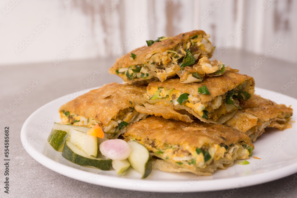 Martabak eggs, Martabak asin or Murtabak, is a popular street food in Indonesia, Asia and the Middle East. is a savory pan-fried pastry stuffed with egg, meat and spices Martabak eggs, Martabak asin or Murtabak, is a popular street food in Indonesia, Asia and the Middle East. is a savory pan-fried pastry stuffed with egg, meat and spices