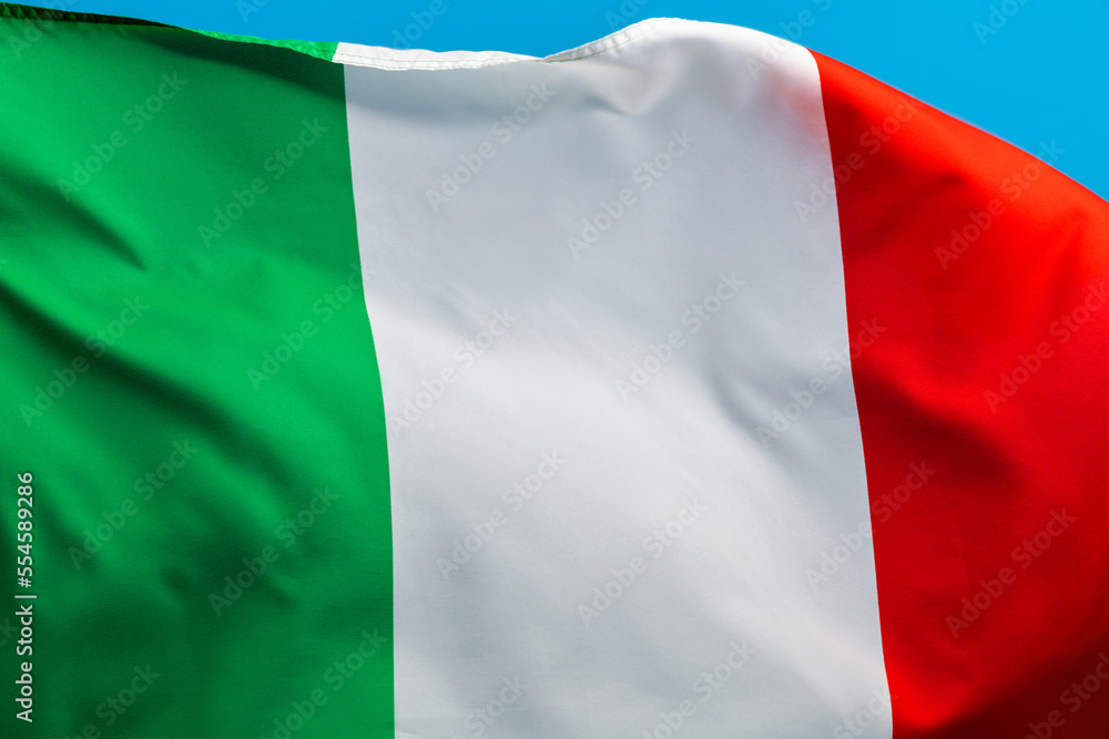 Fototapeta premium Italian flag waving on blue background