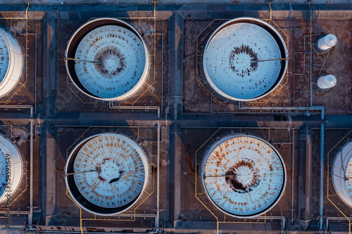 Aerial top view of White oil tank storage chemical petroleum petrochemical refinery product at oil terminal. Oil terminal storage tank in deep seaport for the international order concept. 