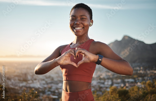 Fotografija Black woman, fitness and heart hands on mountain with music for outdoor sports motivation portrait, travel exercise and freedom