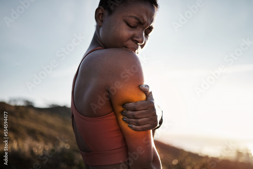 Black woman, sports fitness and arm pain after exercise accident outdoors. Sunset, health and young female athlete with muscle injury, inflammation or fibromyalgia after intense workout or training