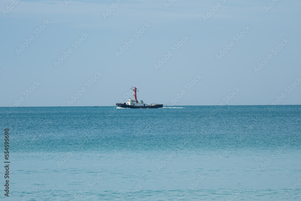 View of a pilot's boat sailing in the blue ocean sea with a foam wake