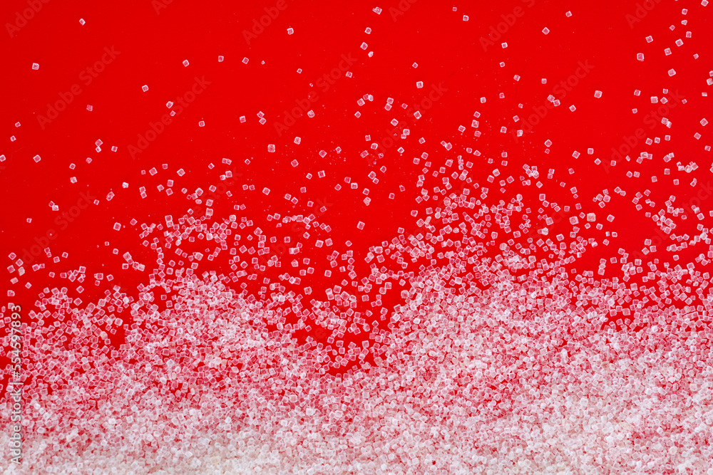 White sugar crystals on blue background White sugar crystals on blue background