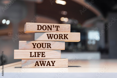 Wooden blocks with words 'Don't work your life away'.