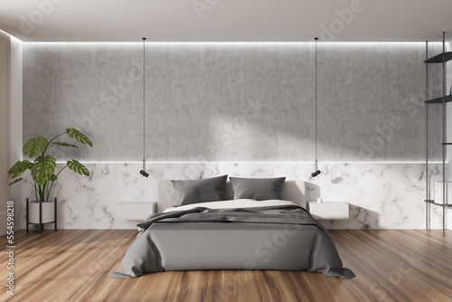 Light bedroom interior with bed and minimal decoration. Empty wall