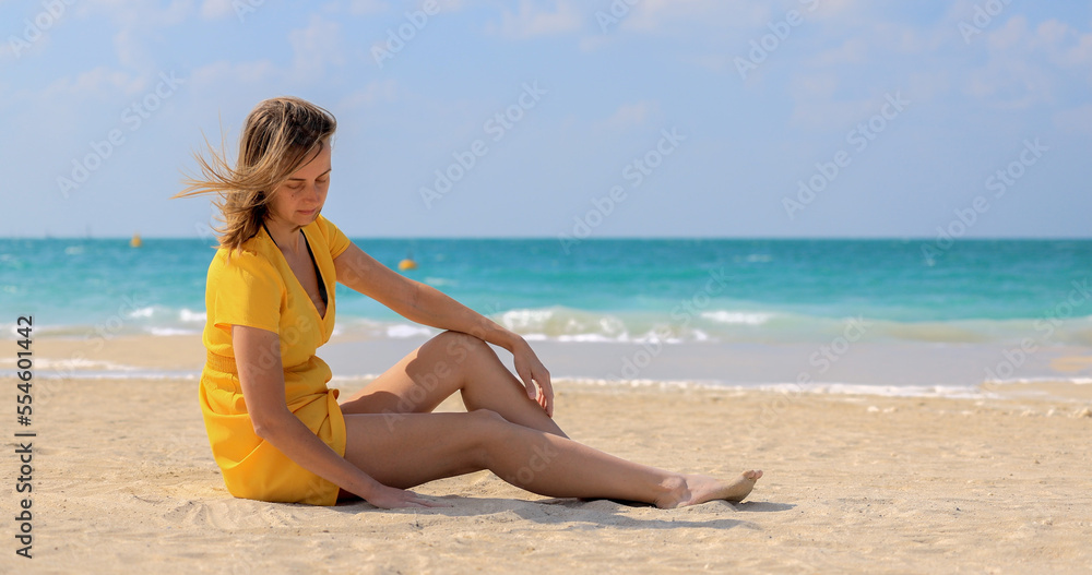 Girl drawing with her hands on the white sand on the beach Girl drawing with her hands on the white sand on the beach