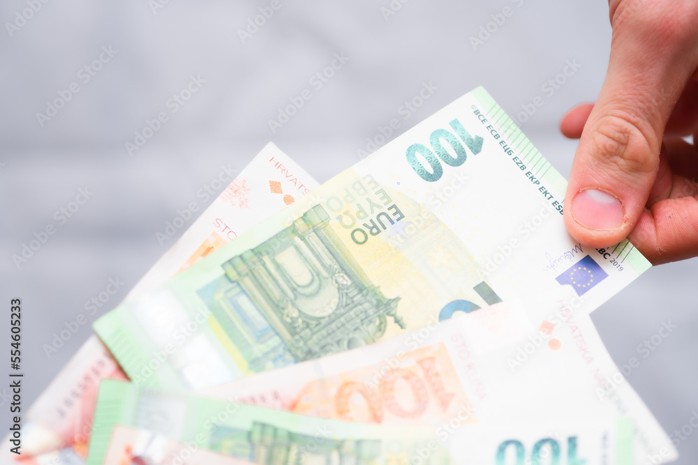 Euro banknotes and Croatian Kuna. Concept showing Croatia's accession to the Eurozone Euro banknotes and Croatian Kuna. Concept showing Croatia's accession to the Eurozone