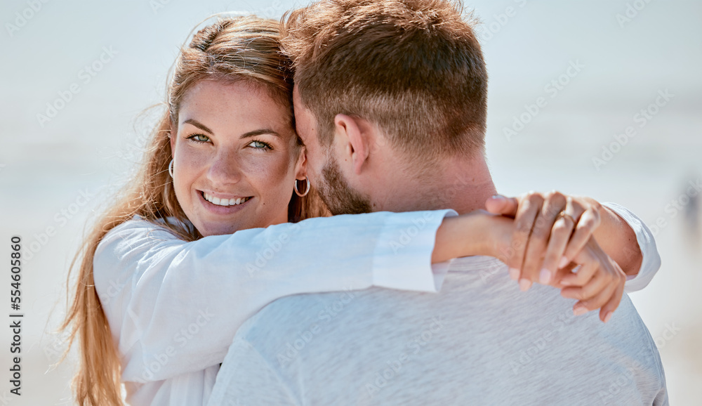 Fototapeta premium Love, couple and hug at beach portrait with smile for bond, trust and gratitude on holiday in Canada. Romance, care and joy of young people in happy relationship enjoying summer sunshine together.