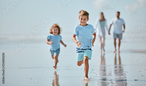 Foto Children, running and beach with a brother and sister together on the sand by the sea or ocean during summer