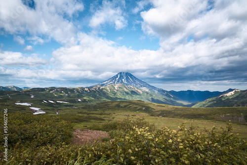 Summer landscape. Vilyuchinsky volcano against blue sky. Kamchatka peninsula
