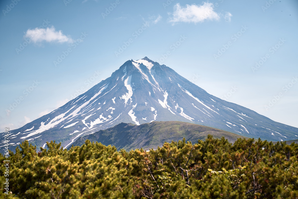 Fototapeta premium Summer landscape. Vilyuchinsky volcano against blue sky. Kamchatka peninsula