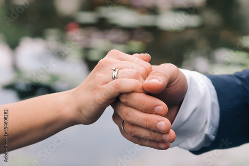 Couple holding hands during wedding photo session