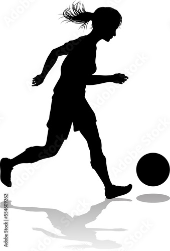 A female soccer football player woman in silhouettes