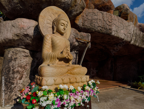 Phu Ruea District, Loei Province, Thailand - 28 July 2022: Buddha statue carved from sandstone meditating at Wat Somdet Phu Ruea Ming Mueang. photo