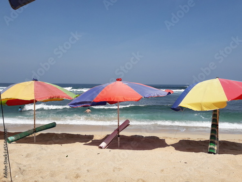 Colorful beach umbrella on the white sand beach. © Felecia
