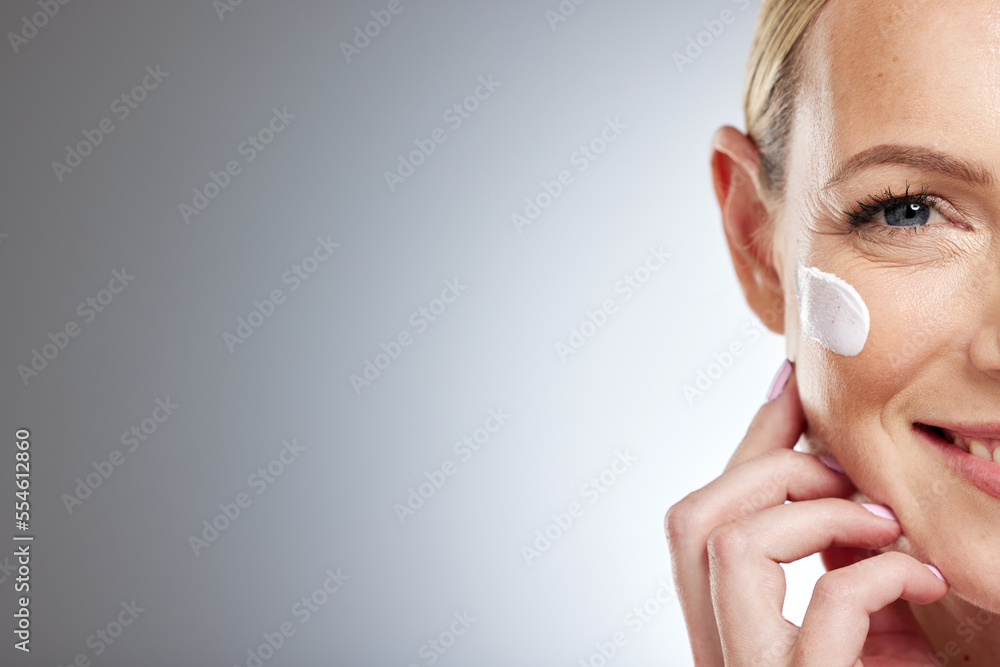 Half face, skincare and cream on woman in studio on gray background mock up space. Beauty portrait, cosmetics and mature female model with facial creme, moisturizing lotion or product for anti aging. Half face, skincare and cream on woman in studio on gray background mock up space. Beauty portrait, cosmetics and mature female model with facial creme, moisturizing lotion or product for anti aging.