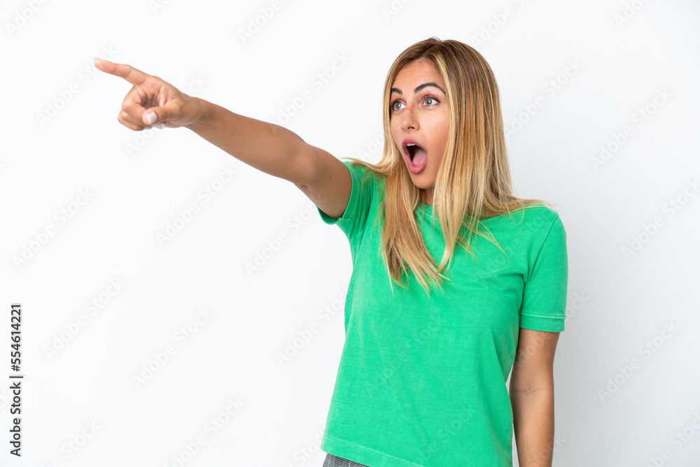 Blonde Uruguayan girl isolated on white background pointing away Blonde Uruguayan girl isolated on white background pointing away
