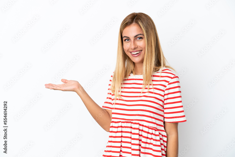 Blonde Uruguayan girl isolated on white background presenting an idea while looking smiling towards Blonde Uruguayan girl isolated on white background presenting an idea while looking smiling towards
