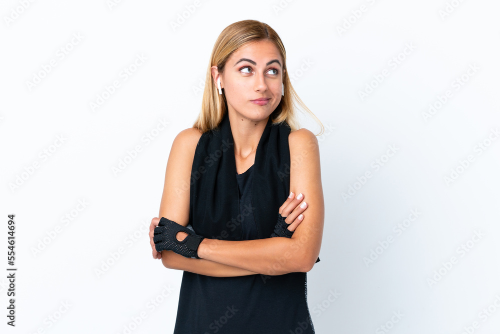 Blonde Uruguayan sport girl isolated on white background making doubts gesture while lifting the shoulders Blonde Uruguayan sport girl isolated on white background making doubts gesture while lifting the shoulders