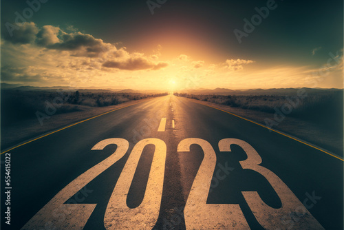  Text 2023 written on the road in the middle of asphalt at sunset. Concept of planning, goal, challenge, new year resolution.