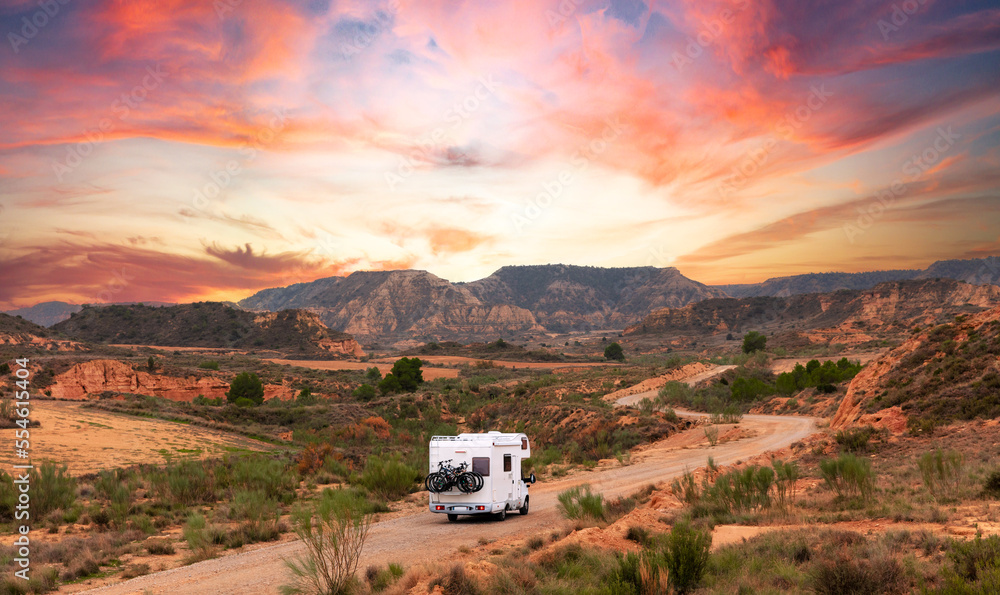 Αυτοκόλλητο Motor home on the road at sunset- travel,  adventure,  road trip concept