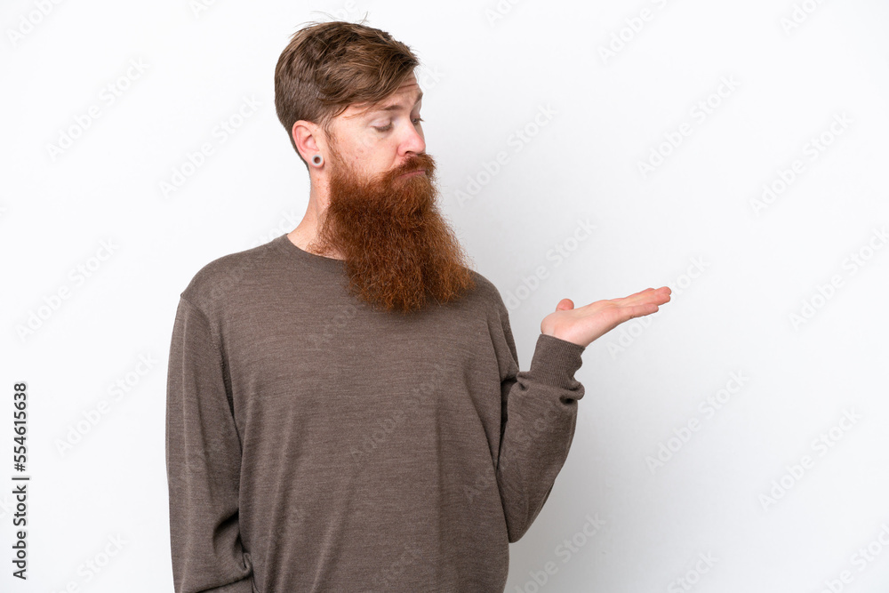 Redhead man with beard isolated on white background holding copyspace with doubts Redhead man with beard isolated on white background holding copyspace with doubts