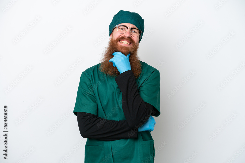 Surgeon redhead man in green uniform isolated on white background with glasses and smiling Surgeon redhead man in green uniform isolated on white background with glasses and smiling