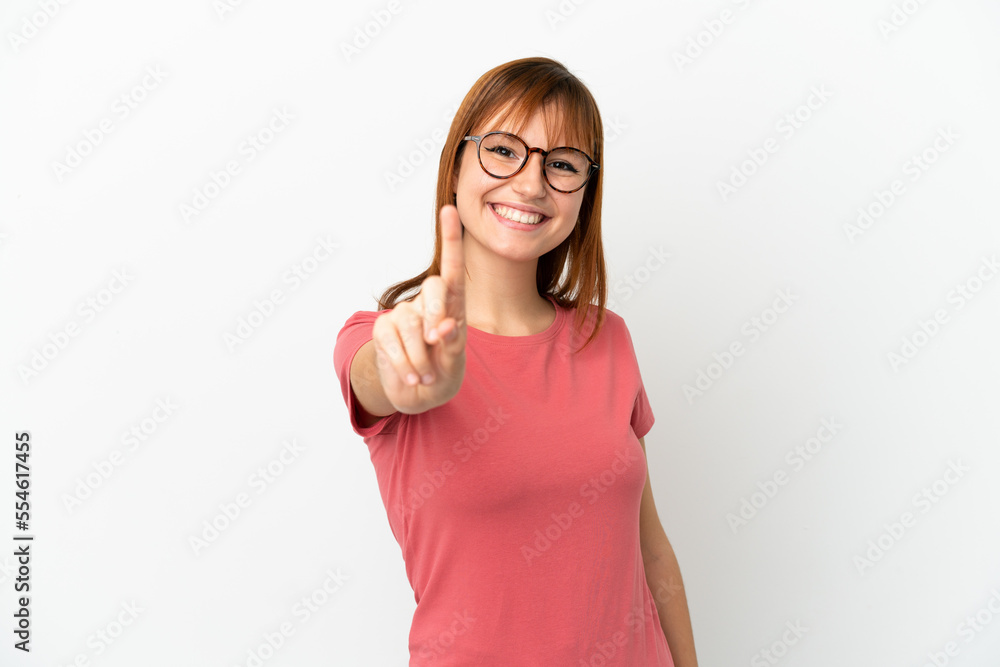 Redhead girl isolated on white background showing and lifting a finger Redhead girl isolated on white background showing and lifting a finger