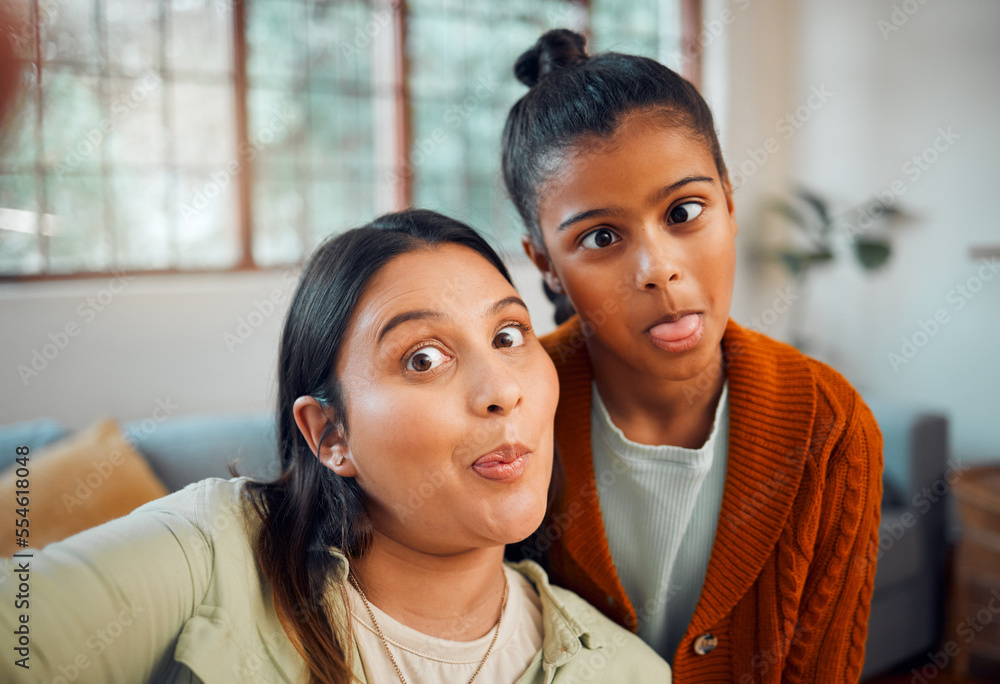 Selfie, mother and daughter with funny, comic face and bonding in home lounge with love, care or together. Mom, girl child and digital picture for happiness, crazy time or social media in living room Selfie, mother and daughter with funny, comic face and bonding in home lounge with love, care or together. Mom, girl child and digital picture for happiness, crazy time or social media in living room