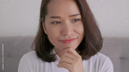 Asian attractive woman with sly smile playful face expression, emotion gesture concept