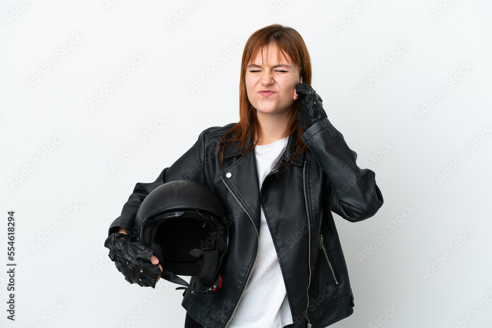 Redhead girl with a motorcycle helmet isolated on white background frustrated and covering ears Redhead girl with a motorcycle helmet isolated on white background frustrated and covering ears