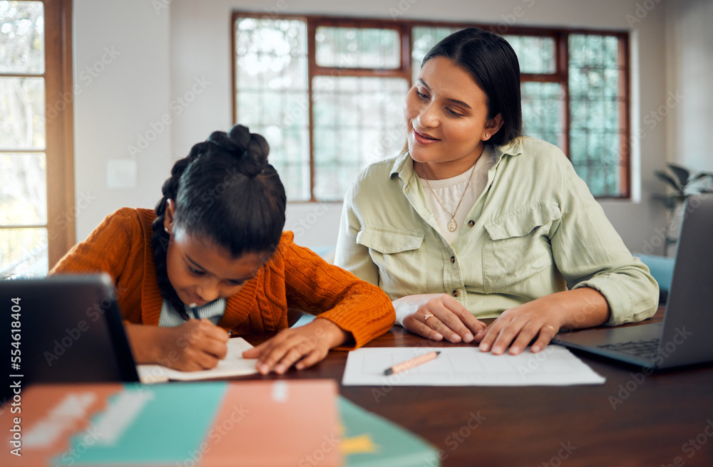 Child, homework and learning with mother while writing in notebook for virtual education class at table at home with support, care and supervision. Woman helping girl with school work in house