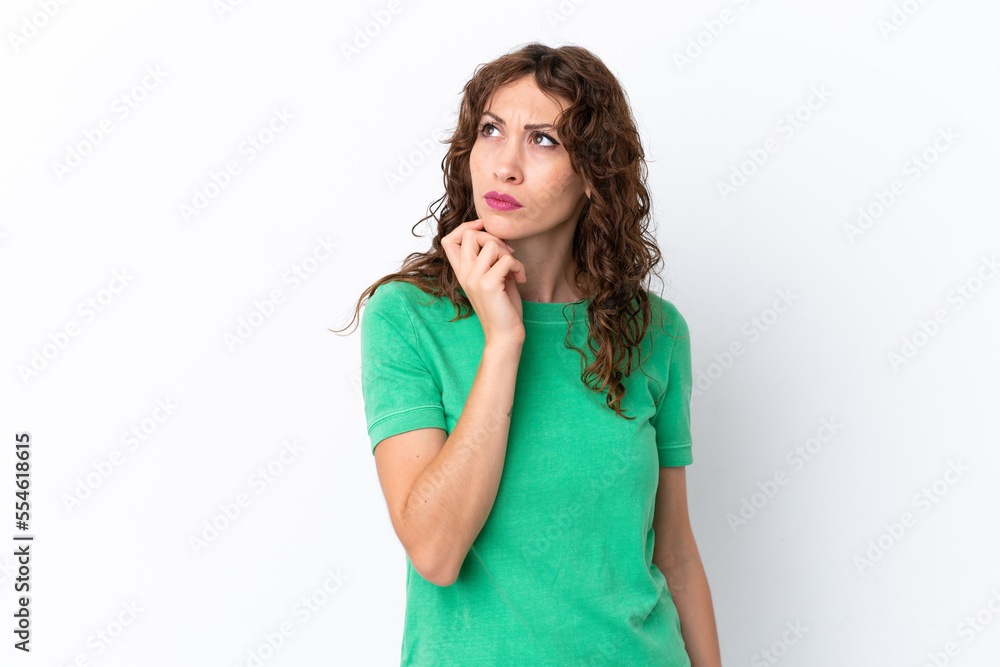 Young woman with curly hair isolated on white background having doubts and thinking Young woman with curly hair isolated on white background having doubts and thinking
