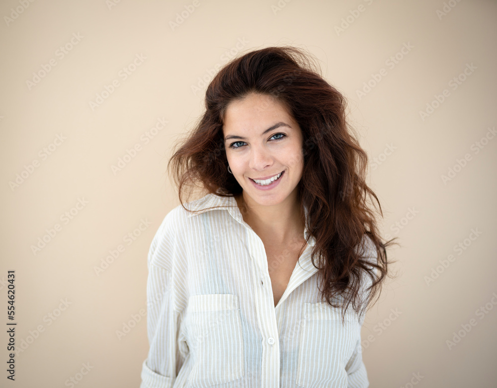 beautiful young woman with long hair posing in front of brown background wearing striped shirt beautiful young woman with long hair posing in front of brown background wearing striped shirt