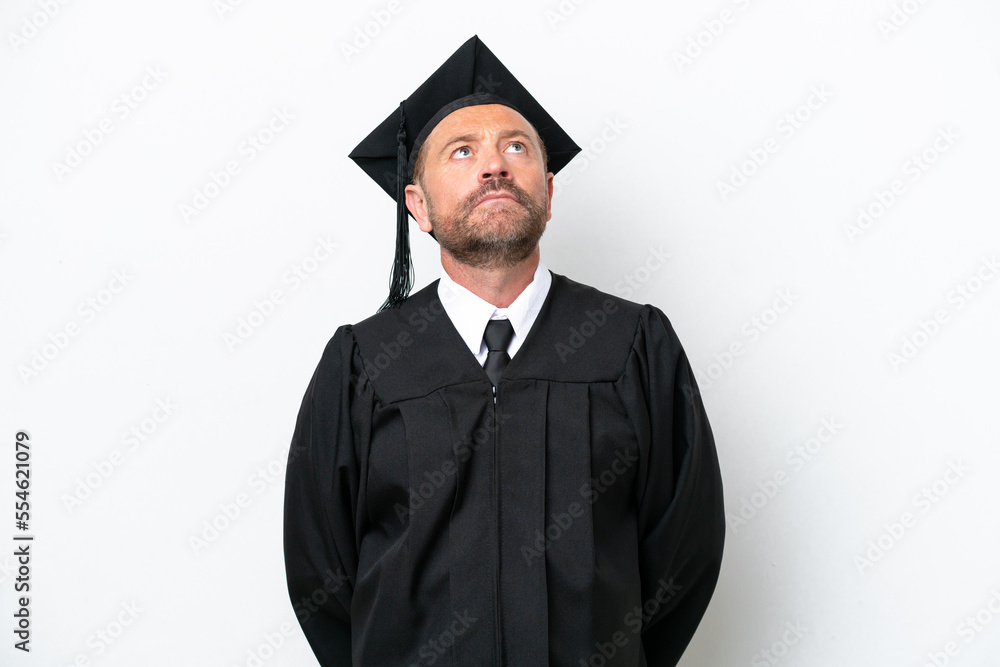 Middle age university graduate man isolated on white background and looking up Middle age university graduate man isolated on white background and looking up