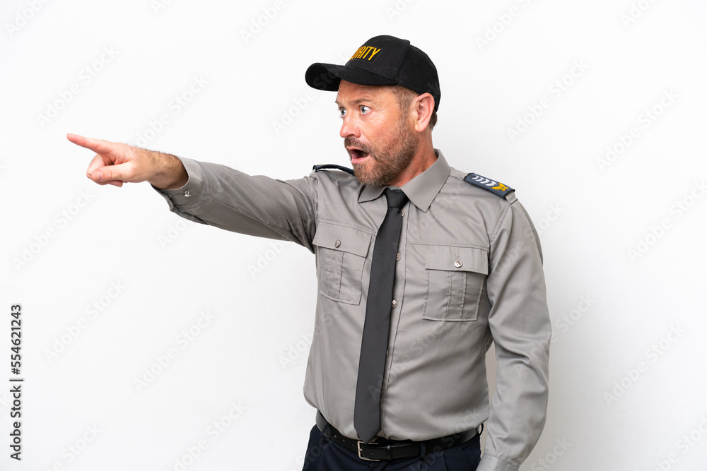 Middle age security man isolated on white background pointing away Middle age security man isolated on white background pointing away