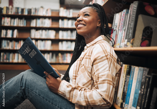 Black woman student, reading or library floor for religion, study or bible in research, focus or learning. African college student, christian education or studying god book for knowledge in Chicago