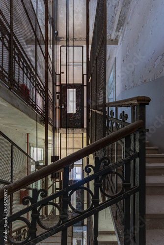 A vertical shot of a staircase in an old abandoned hospital