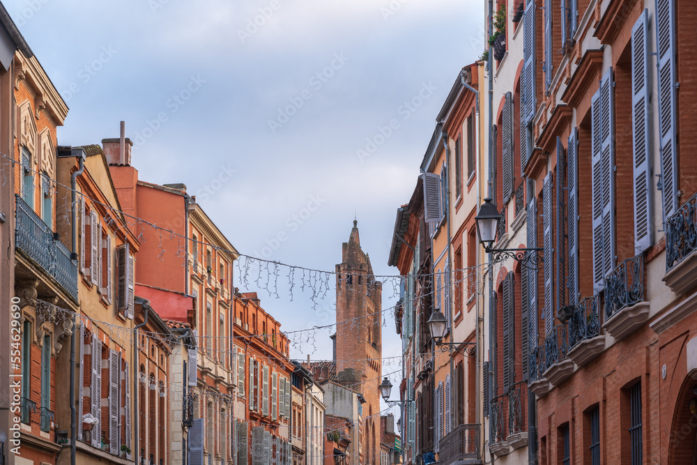 Scenic urban landscape of colorful ancient brick buildings in Rue du Taur in the famous pink city of Toulouse, France
