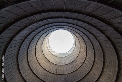 Inside a cooling tower of a nuclear power plant. View upwards, sky with haze. abandoned place