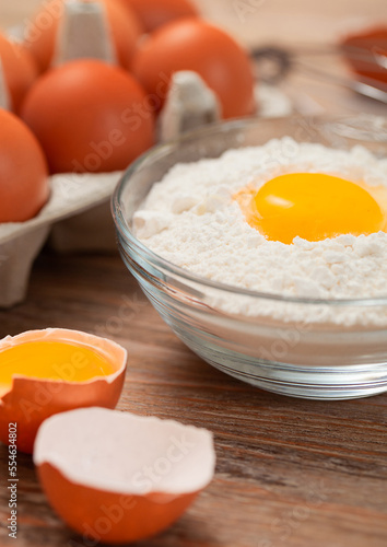 Wallpaper Mural Bowl plate with flour and egg yolk on wooden background with fresh raw eggs Torontodigital.ca