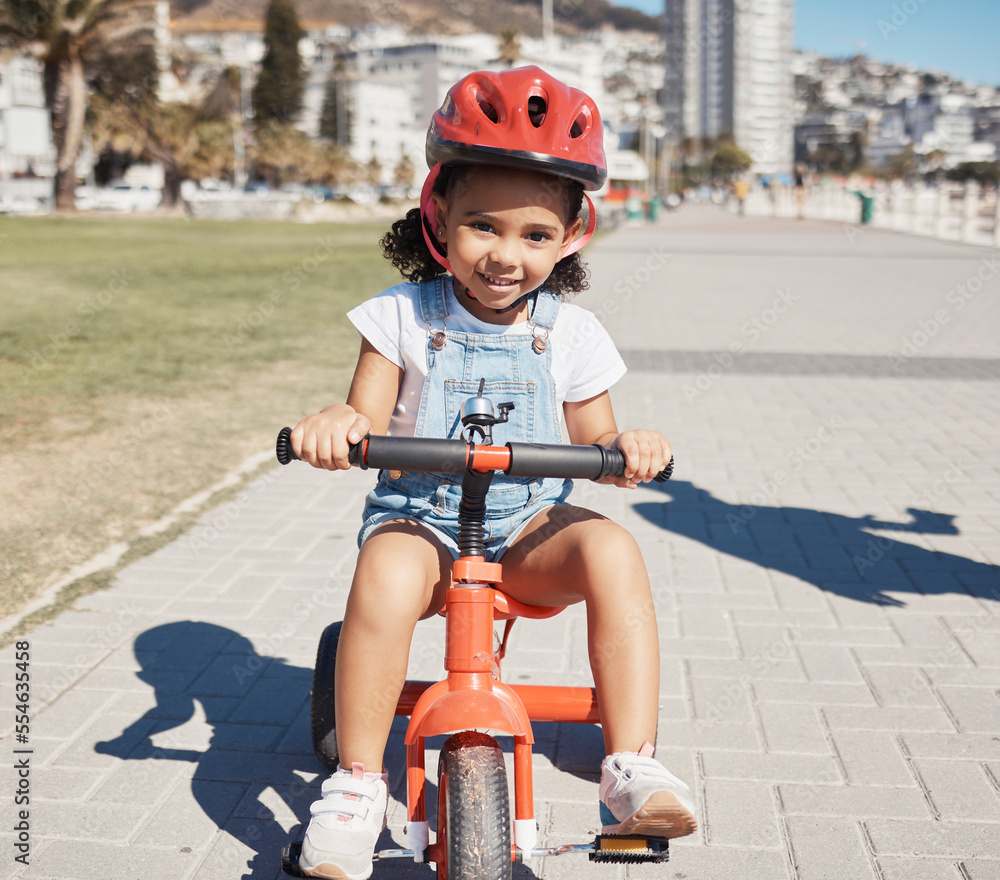 Φωτογραφία Portrait, girl child and cycling on sidewalk, learning to ride bike or healthy childhood development